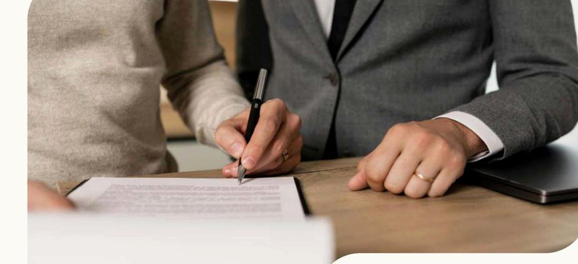 Personas revisando y firmando un documento de negocios